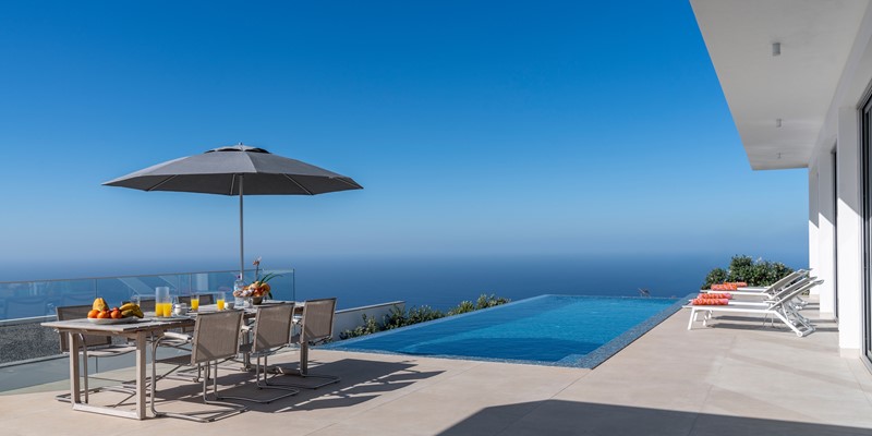 Infinity Pool And Outdoor Dining At Oceanair By Ourmadeira Villas In Madeira