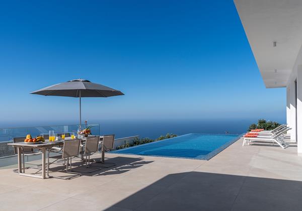 Infinity Pool And Outdoor Dining At Oceanair By Ourmadeira Villas In Madeira