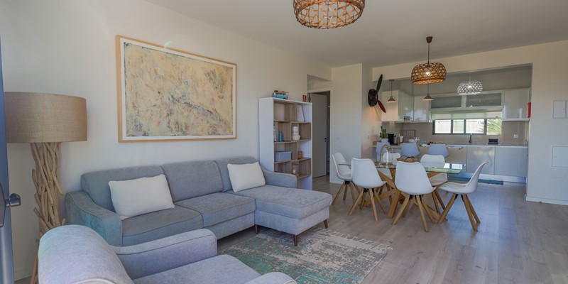 The Spacious Open Plan Livjng Area And Contemporary Kitchen Of Vila Diana In Porto Santo By Ourmadeira