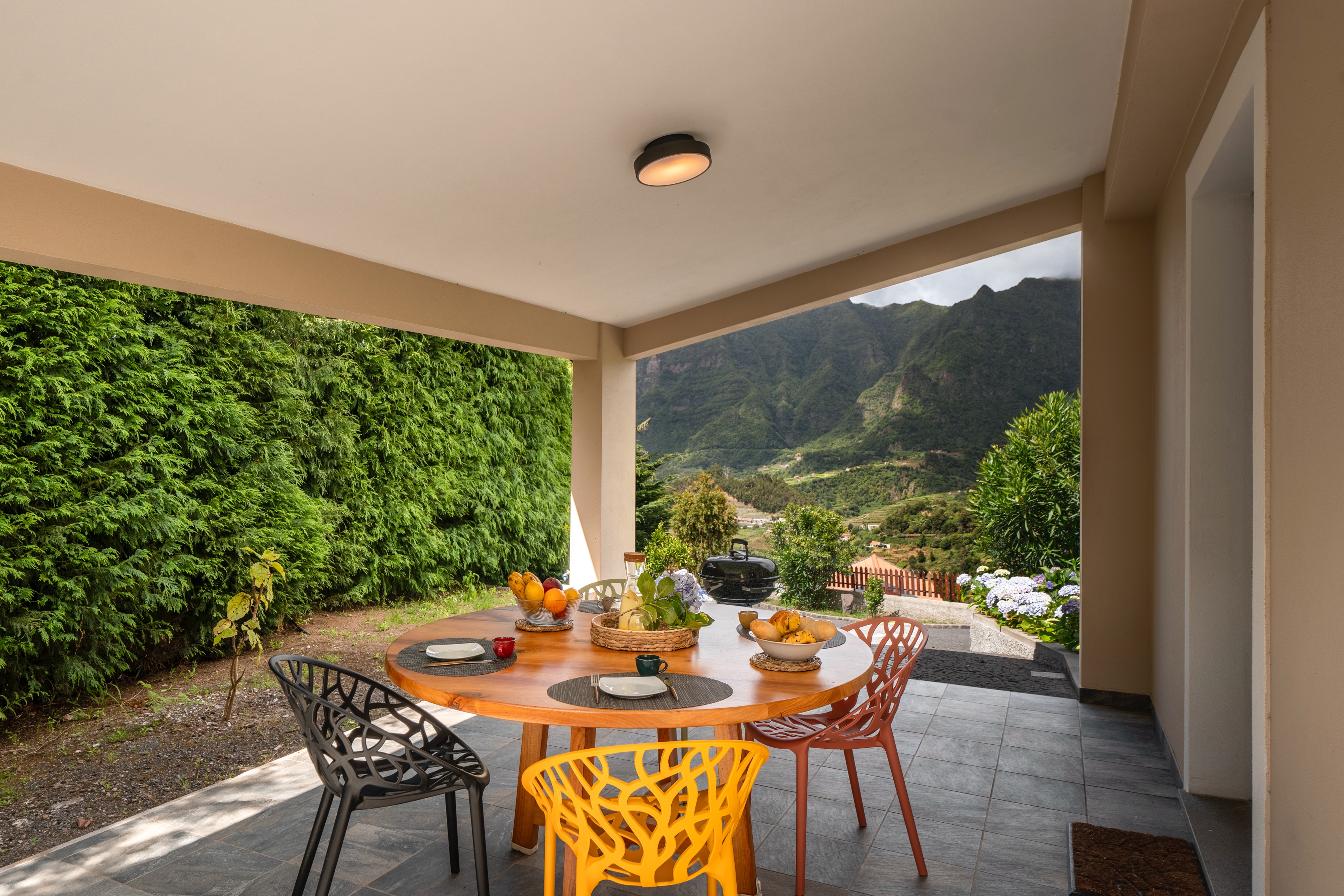 The Covered Outdoor Dining Area Of Casa Hortencia By Ourmadeira With The Beautiful Contryside Views Of The Sao Vicente Mountains
