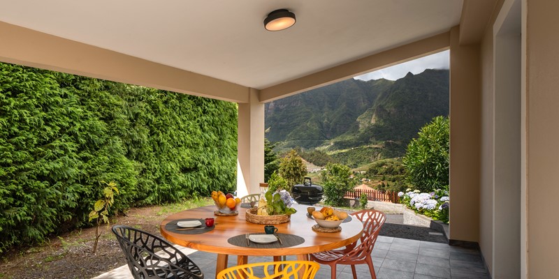 The Covered Outdoor Dining Area Of Casa Hortencia By Ourmadeira With The Beautiful Contryside Views Of The Sao Vicente Mountains