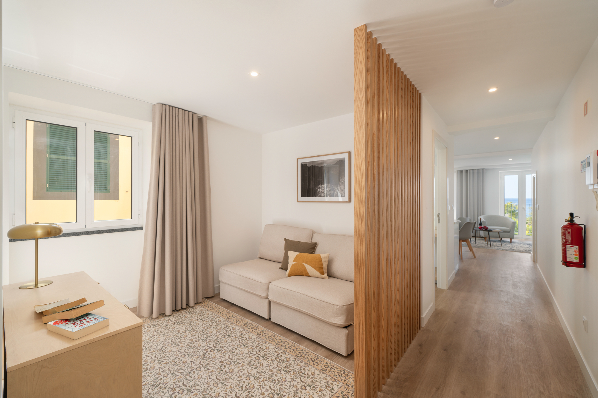 Ourmadeira A Cozy Room Featuring A White Couch Beside A Classic Wooden Door Creating A Warm And Inviting Atmosphere