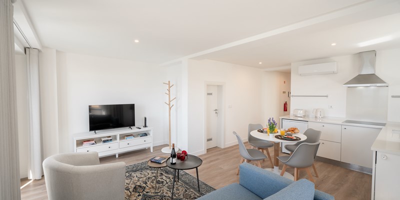 Ourmadeira Modern Living Room Showcasing A Blue Couch And A TV Creating A Welcoming Space For Relaxation And Fun The Fort Of Old Town