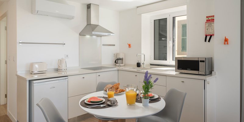 The Fort Of Old Town Kitchen With A Bright White Table Accompanied By Stylish Chairs Creating An Inviting Space For Meals And Conversations