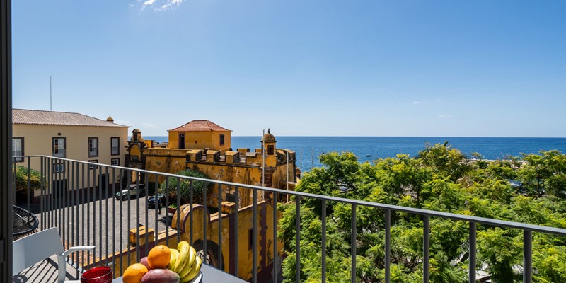 The Fort Of Old Town With A Delightful Balcony With A Table Filled With An Array Of Fresh Colorful Fruits Perfect For Enjoying The Outdoors And Seaview