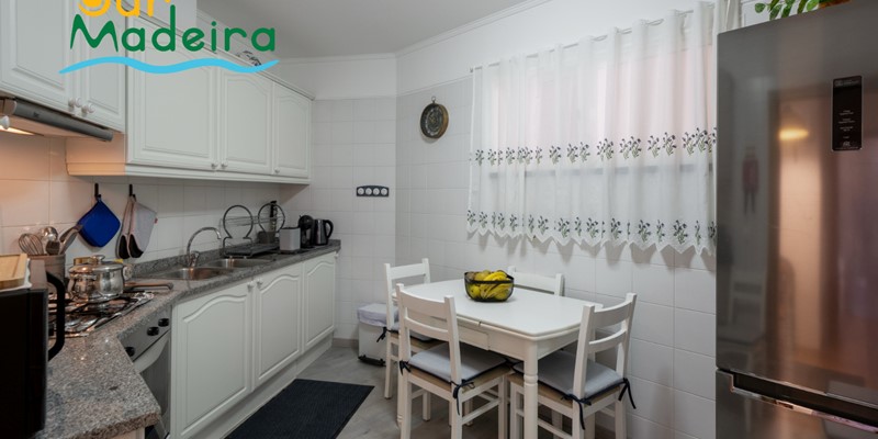 The Fully Equipped Kitchen And Kitchen Dining Table At Alamos Uptown Apartment In Funchal By Ourmadeira