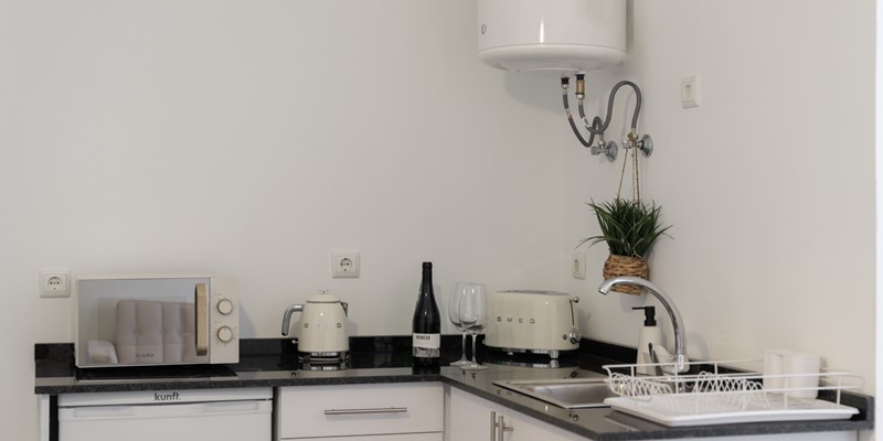 The Breakfast Corner With Microwave Toaster And Kettle At Apartamentos Taberna Studio 2 By Ourmadeira