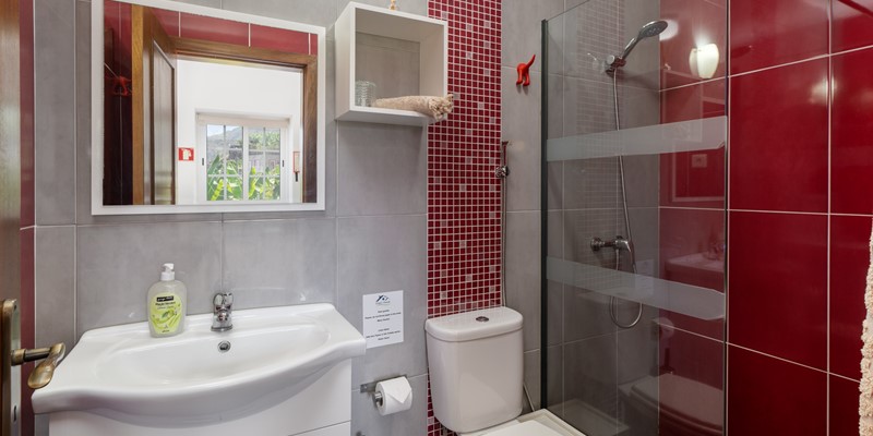 Additional Full Bathroom At Graycis House By Ourmadeira Featuring A Spacious Walk In Shower Stylish Fixtures And A Warm Inviting Design