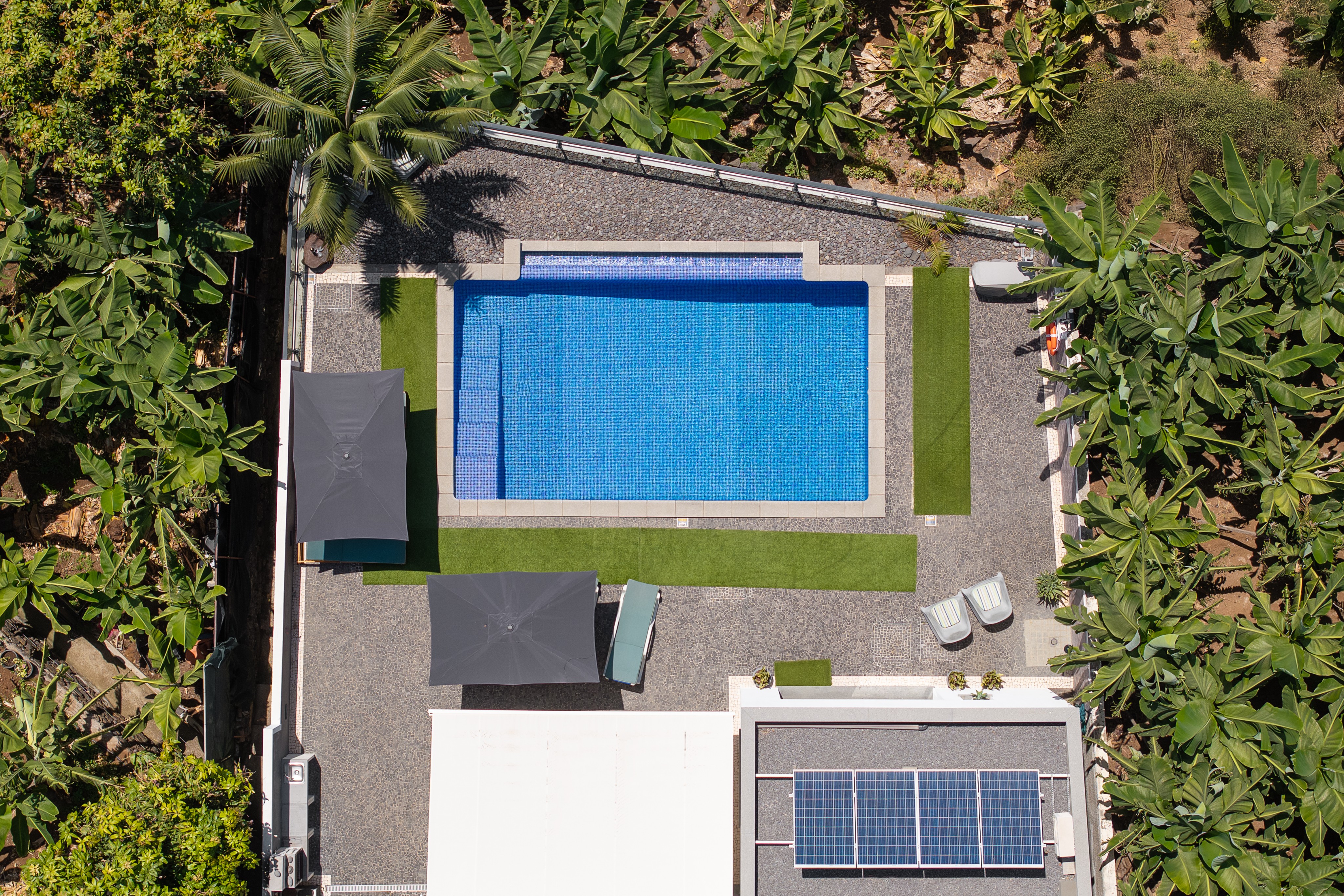 Drone View Of Graycis House By Ourmadeira Highlighting The Surrounding Banana Groves Architectural Layout Swimming Pool And Scenic Landscape Of Madeira Island