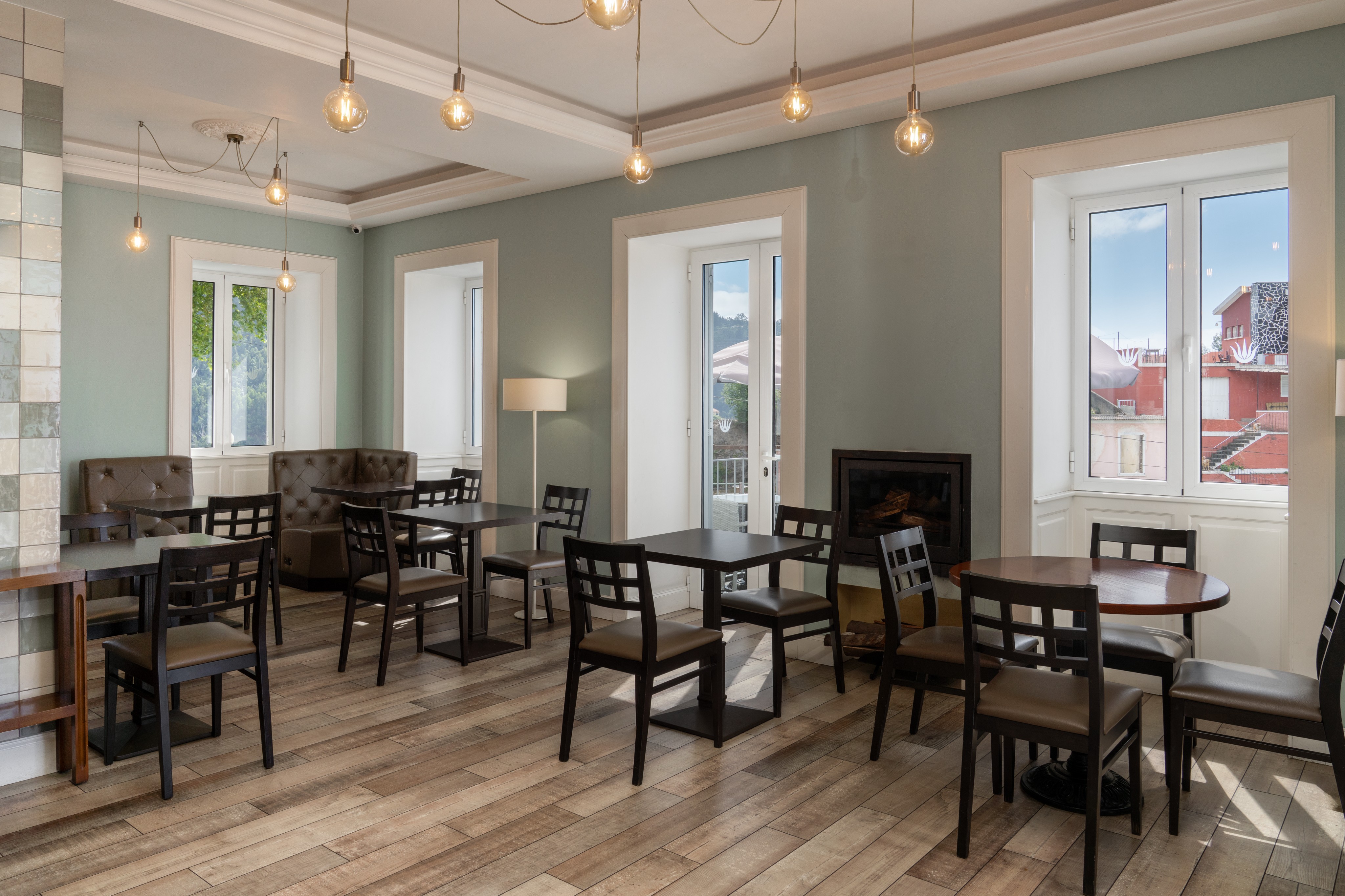 Bright Breakfast Room At Babosas Village With Natural Sunlight Streaming Through Large Windows Creating A Warm And Inviting Atmosphere