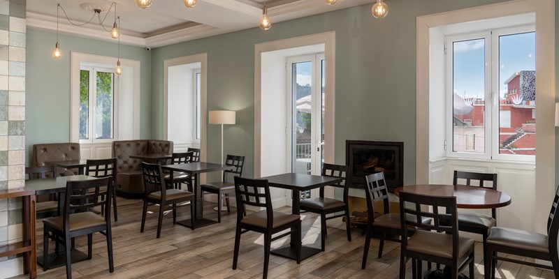 Bright Breakfast Room At Babosas Village With Natural Sunlight Streaming Through Large Windows Creating A Warm And Inviting Atmosphere