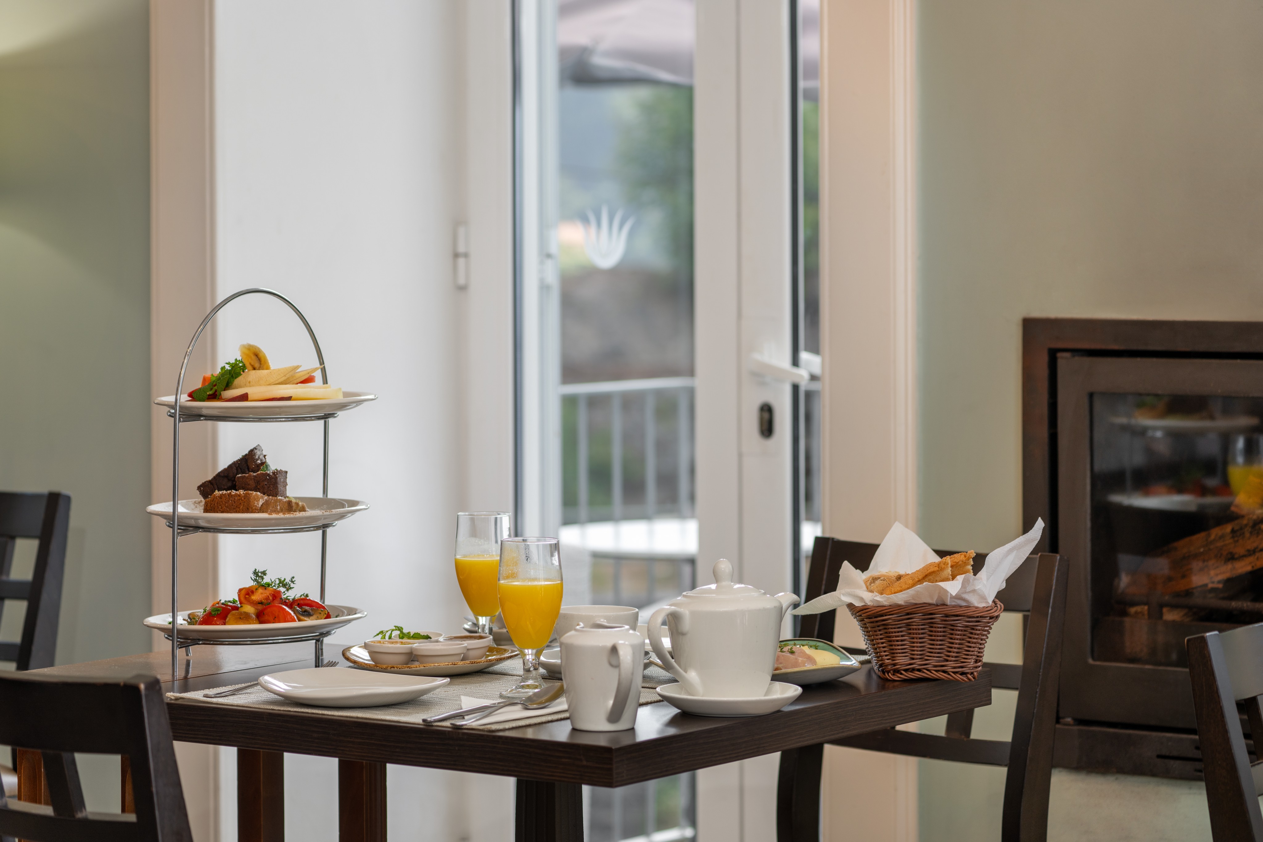 Close Up Of A Breakfast Selection At Babosas Village Featuring Fresh Fruit Pastries Bread Orange Juice And Coffee Arranged On A Neatly Set Table