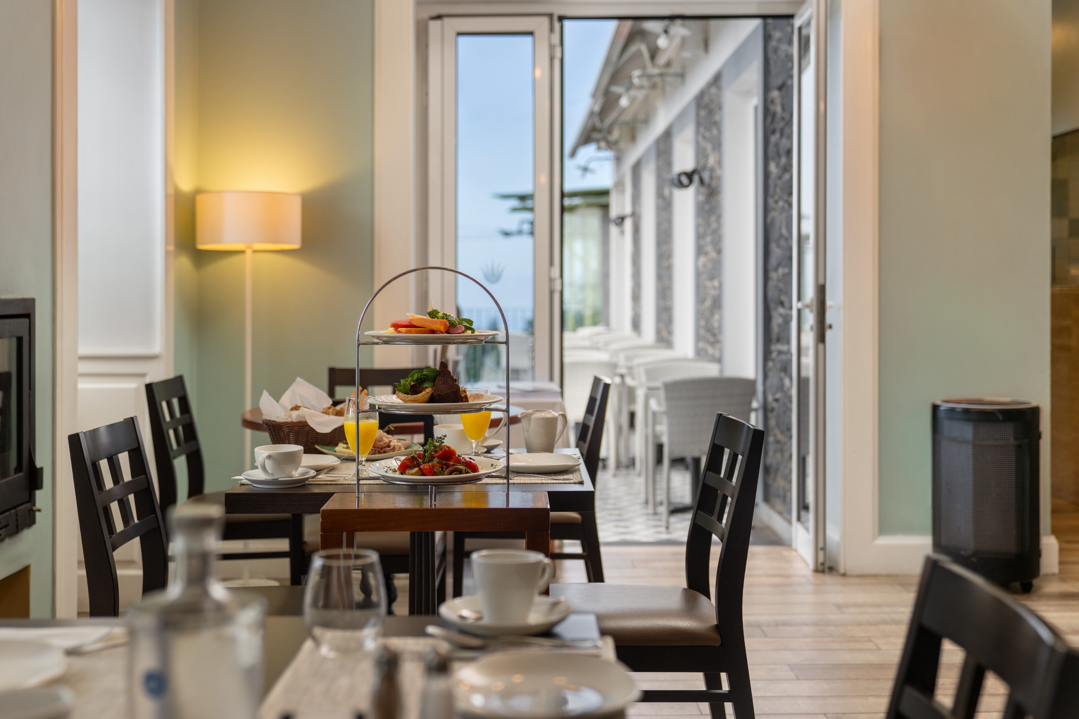Close Up Of A Breakfast Table At Babosas Village Featuring Fresh Fruit Pastries Bread Orange Juice And Coffee With Elegant Table Setup In A Cozy Dining Room