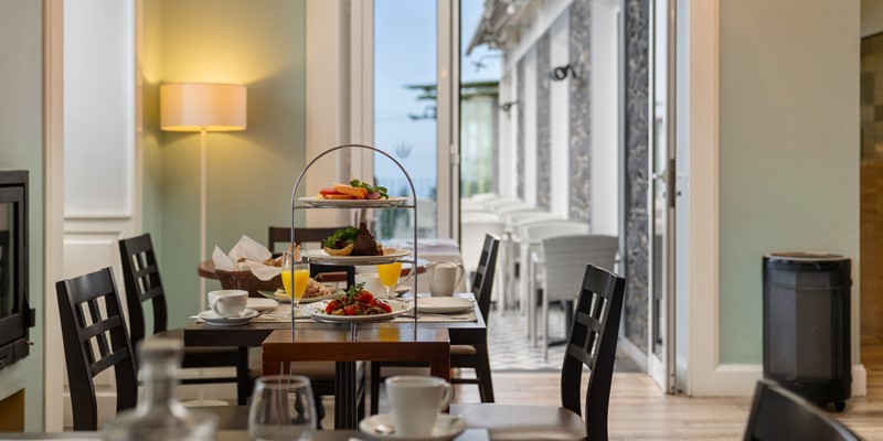 Close Up Of A Breakfast Table At Babosas Village Featuring Fresh Fruit Pastries Bread Orange Juice And Coffee With Elegant Table Setup In A Cozy Dining Room
