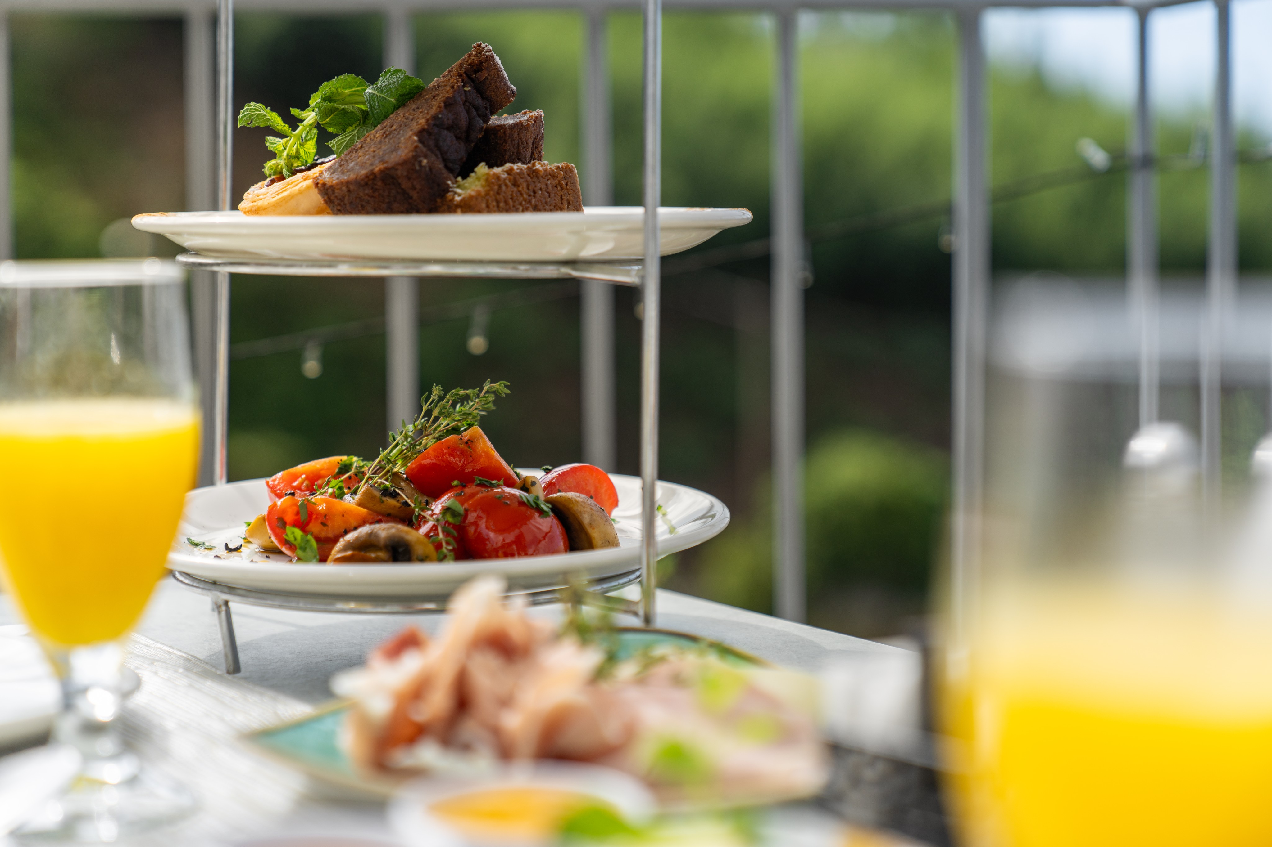 Detailed Shot Of Breakfast At Babosas Village By Ourmadeira Showing Fresh Fruit Slices Homemade Pastries Crusty Bread Orange Juice And A Steaming Cup Of Coffee Arranged With Care