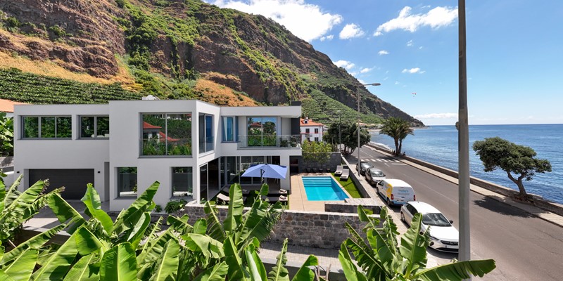 A Panoramic View Over The Landscape And Modern Building At Beachfront By Ourmadeira