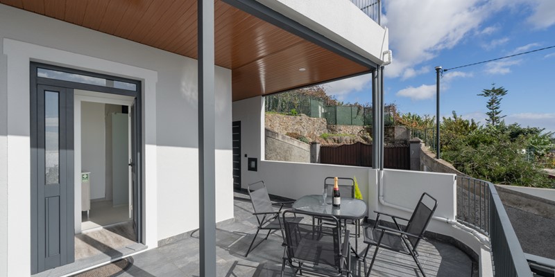 The Outdoor Dining Table And Main Entrance To The Villa At Casa Da Vinha By Ourmadeira