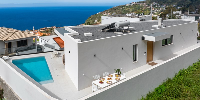 A View Over The Villa With Its Beautifull Outside Dinng Area Heated Swimmig Pool And Sea View At Amani By Ourmadeira
