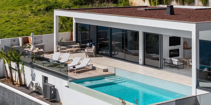 Outdoor Pool Area At Infinite Atlantic By Ourmadeira Featuring Sun Loungers Solarium And Al Fresco Dining Space With Atlantic Views In Madeira