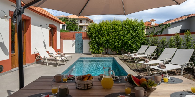 The Beautifully Landscaped Outdoor Area With A Private Heated Swimming Pool Outdoor Shower Barbecue And A Stylish Dining Space For Family Meals And Evening Gatherings At Casa Da Tia By Ourmadeira
