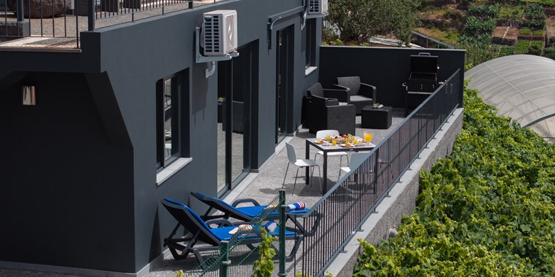 The Large Outdoor Terrace With Bbq Dining Areas And Sun Beds At Solmar By Ourmadeira