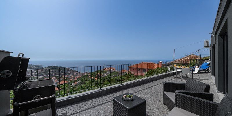 The Large Outdoor Terrace With BBQ Dining Area And Sun Beds To Relax After A Day Unwinding Madeira At Solmar Apartment By Ourmadeira