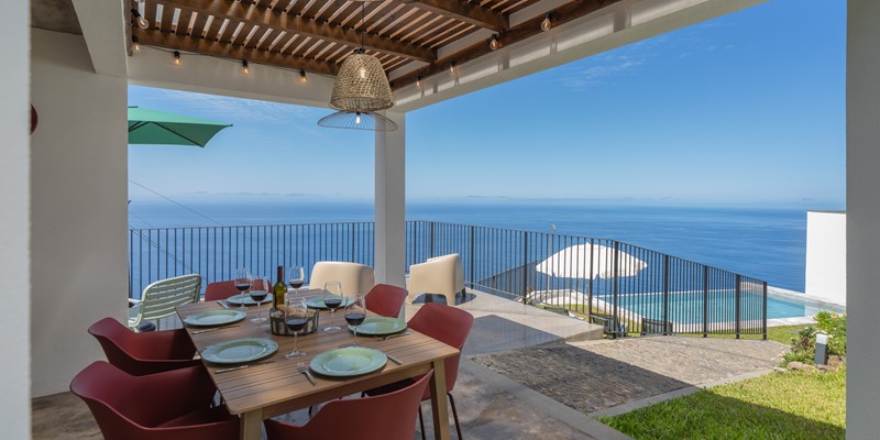 The Elegantly Furnished Outdoor Area Featuring A Built In Barbecue And Beautiful Views Over The Swimming Pool Perfect For Relaxed Al Fresco Dining At Ocean Hills By Ourmadeira